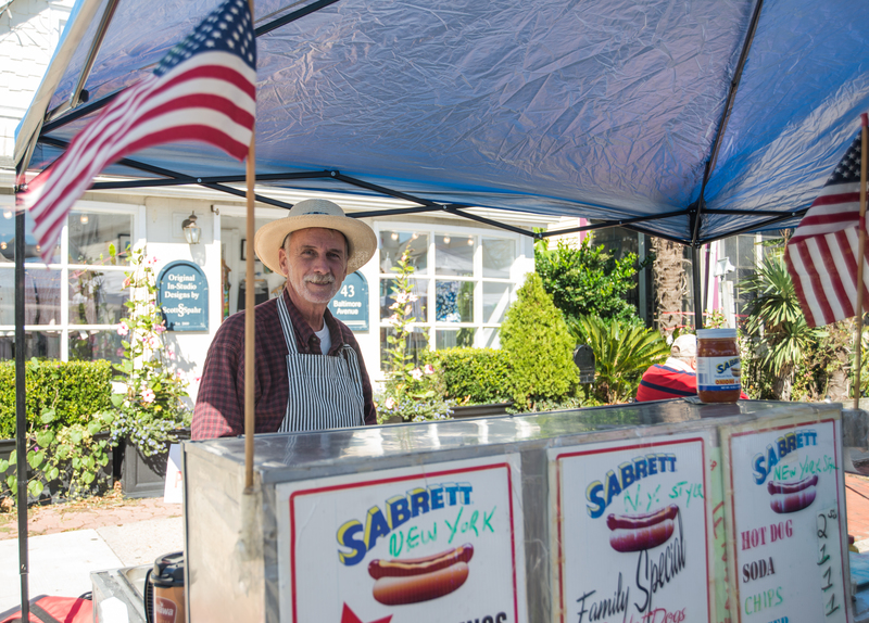 Phil Manera spends Sunday serving up Sabrett hot dogs at CAMP Rehoboth's Block Party; he parks his cart at Nuttle Lumber during the week. BY DENY HOWETH